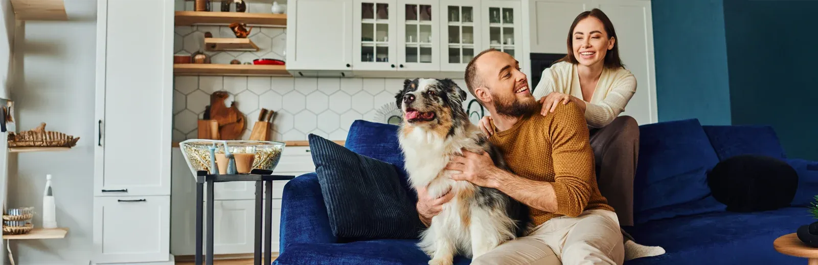 man playing with dog in living room