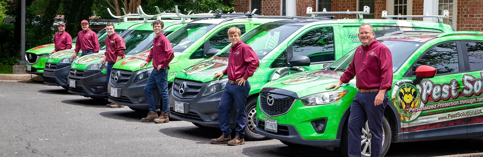 Pest Solutions Team standing next to vehicle fleet