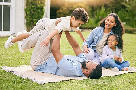 family outside in yard playing