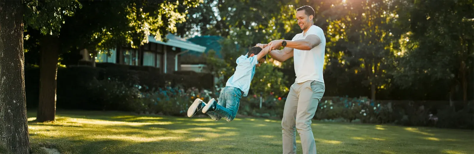 father and son playing outside mosquito free lawn